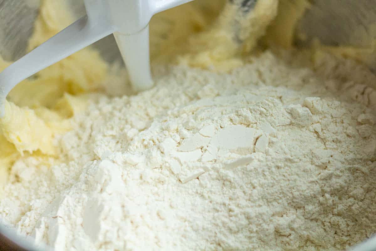 Flour mixture added to wet ingredients in the bowl of a stand mixer