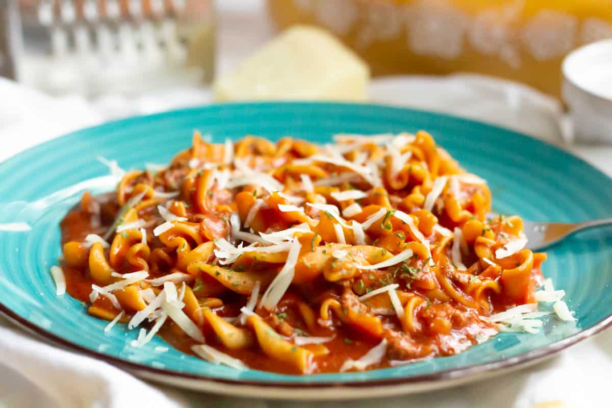 So Easy Tomato Beef Kluski | thewendthousekitchen.com Tomato beef kluski on a turquoise plate with a fork