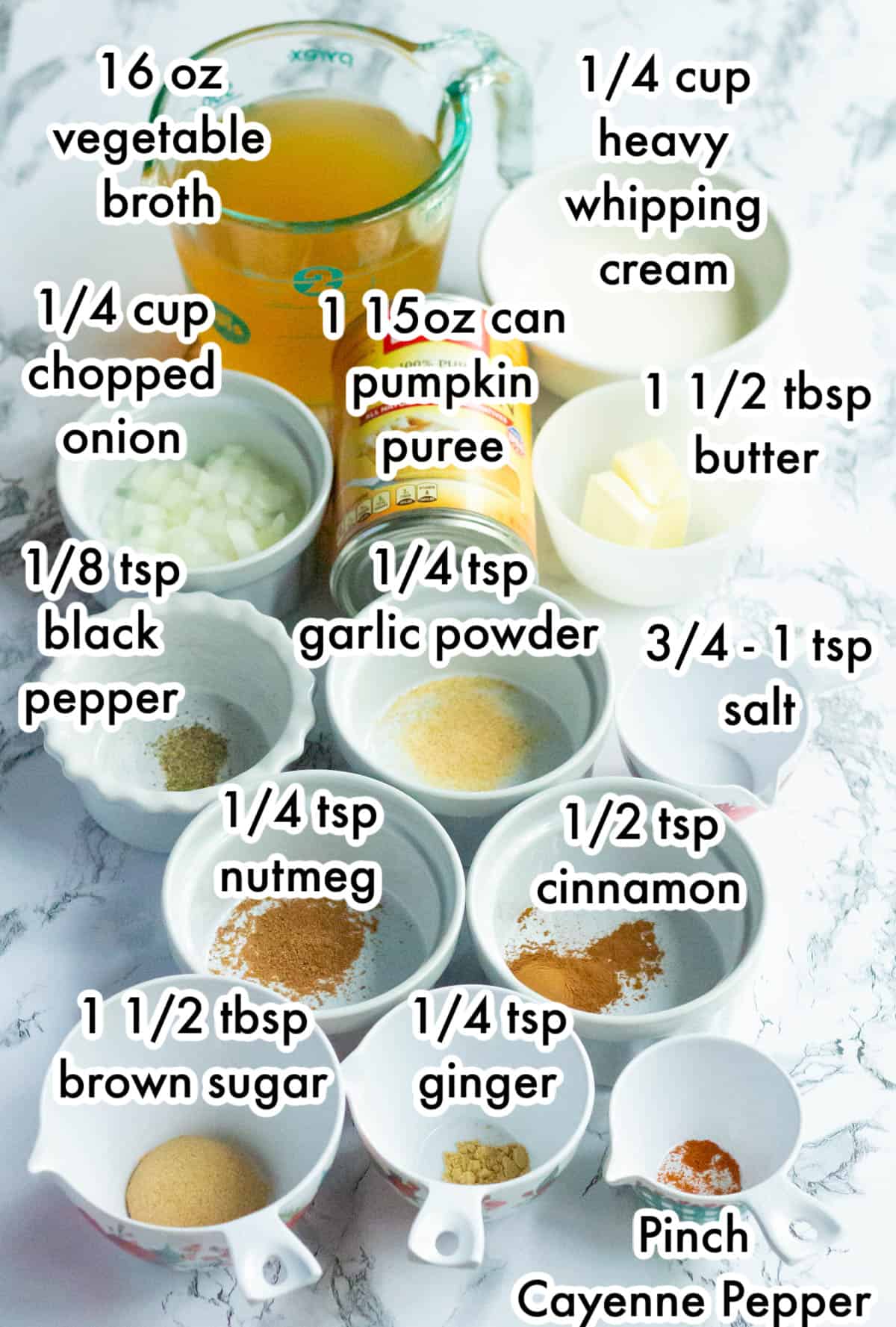All of the ingredients for pumpkin bisque in individual bowls and labeled