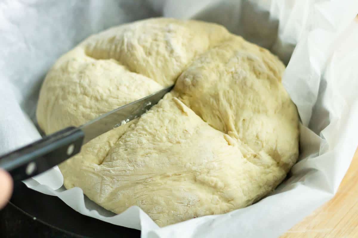 Crusty No Knead Bread | thewendthousekitchen.com Carving an "X" in the bread dough with a knife