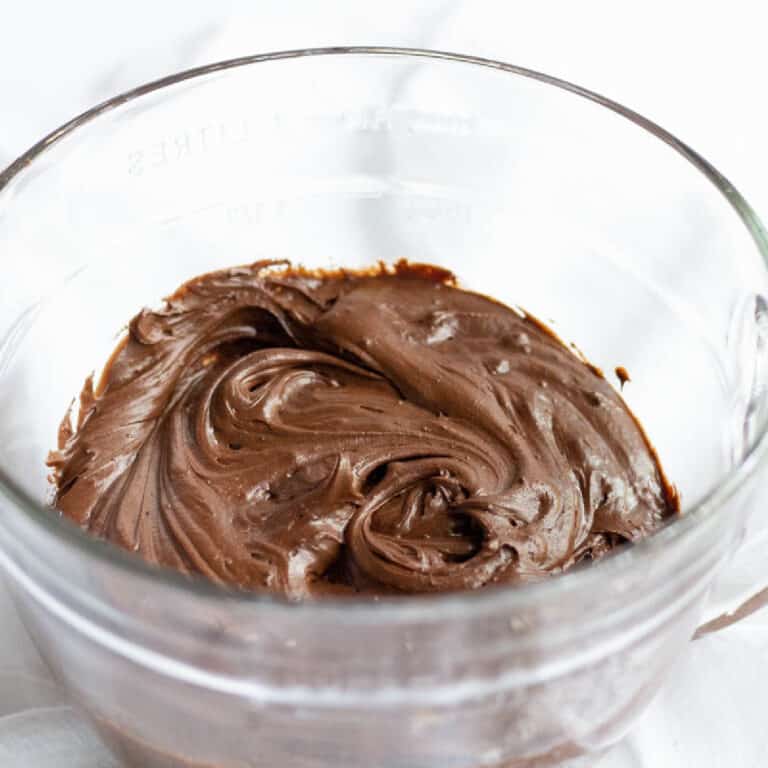 Chocolate Fudge frosting in a giant glass measuring bowl
