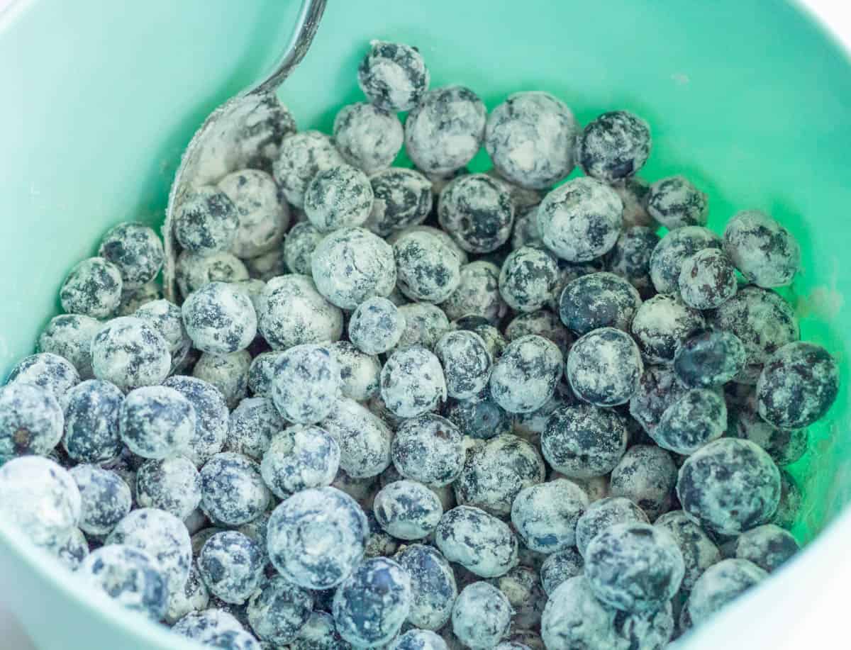 The Best Blueberry Cream Cheese Muffins | thewendthousekitchen.com Flour-coated blueberries inside of a mixing bowl