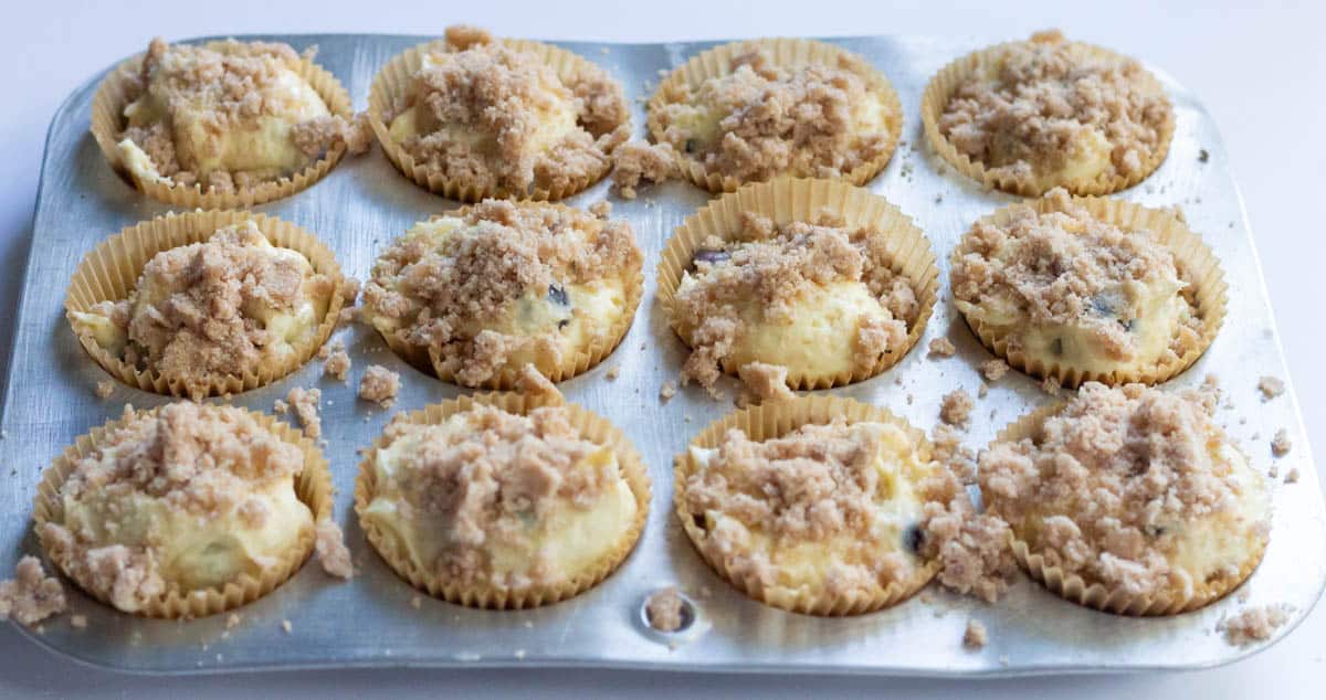 The Best Blueberry Cream Cheese Muffins | thewendthousekitchen.com Muffin batter added to the muffin cups in a muffin pan