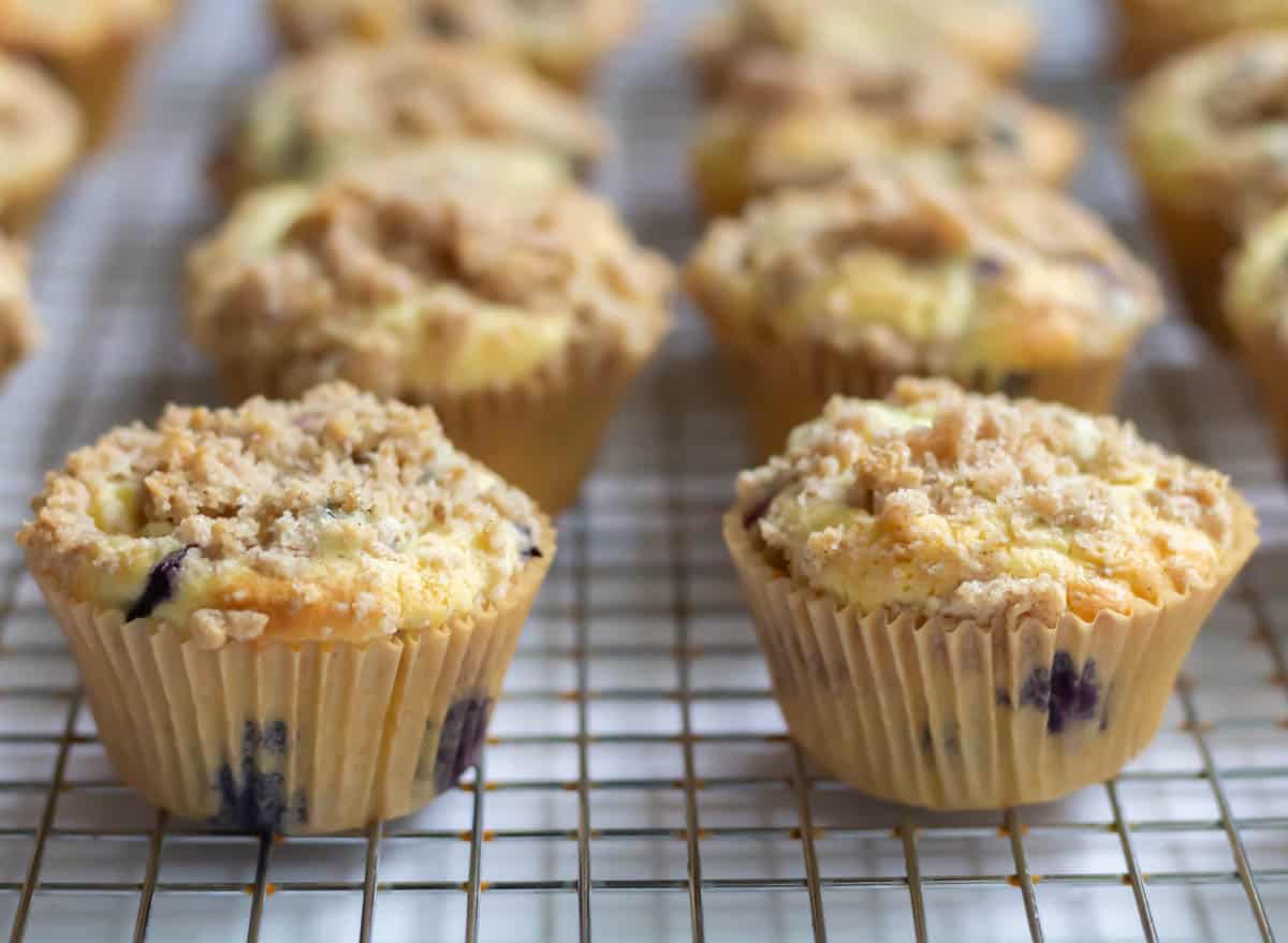 The Best Blueberry Cream Cheese Muffins | thewendthousekitchen.com Blueberry muffins cooling on a cooling grid