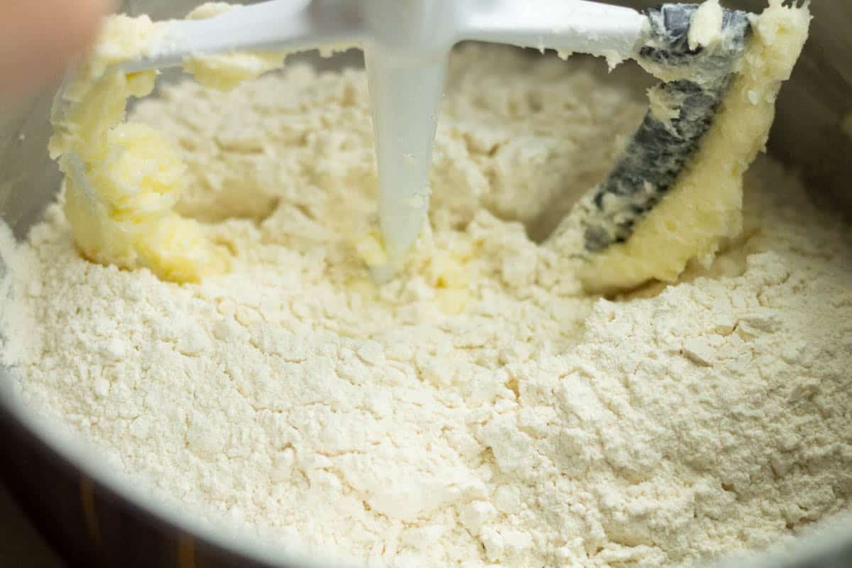 Old-Fashioned Butter Cookie Recipe | thewendthousekitchen.com Flour added to butter and sugar mixture in the bowl of a stand mixer with a paddle attachment.