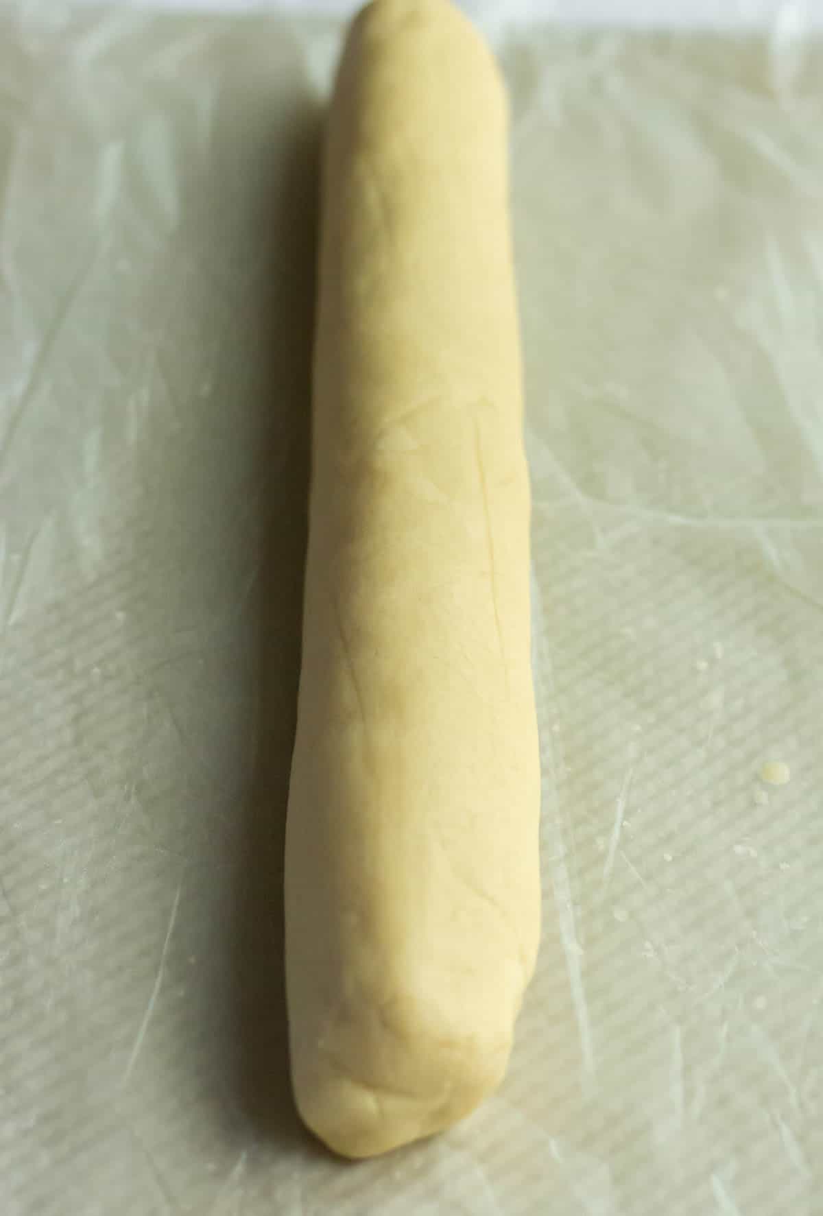 Old-Fashioned Butter Cookie Recipe | thewendthousekitchen.com Dough rolled into a log on waxed paper.