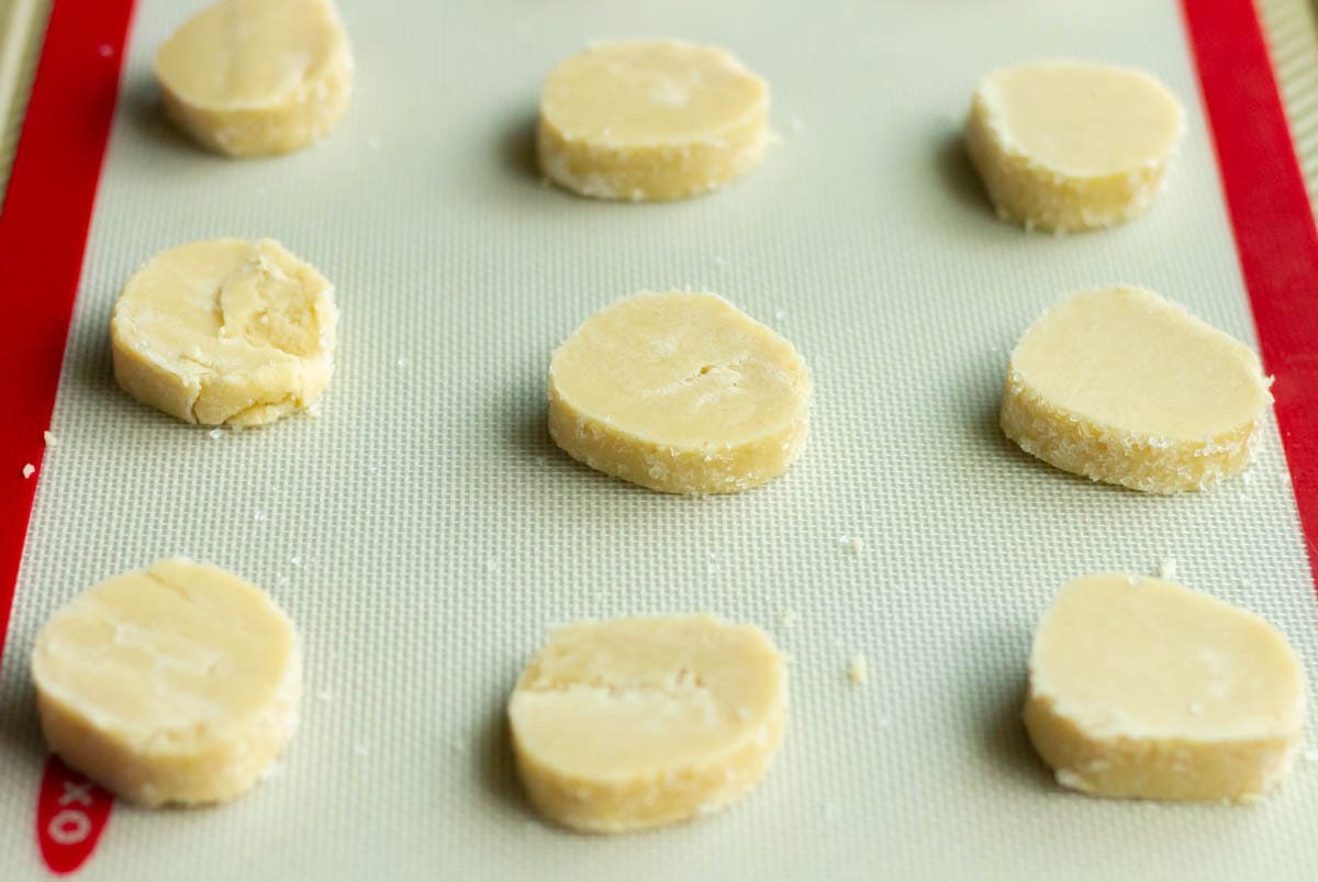 Old-Fashioned Butter Cookie Recipe | thewendthousekitchen.com Cookie dough slices on a Silpat on a cookie sheet.