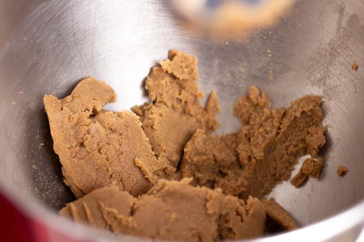 Butter, sugar and brown sugar mixed together in the bowl of a stand mixer