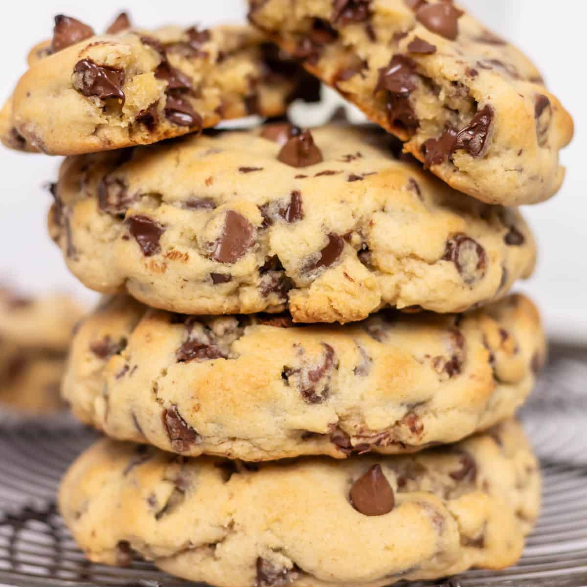 Stacked copycat Levain cookies with the top cookie in half