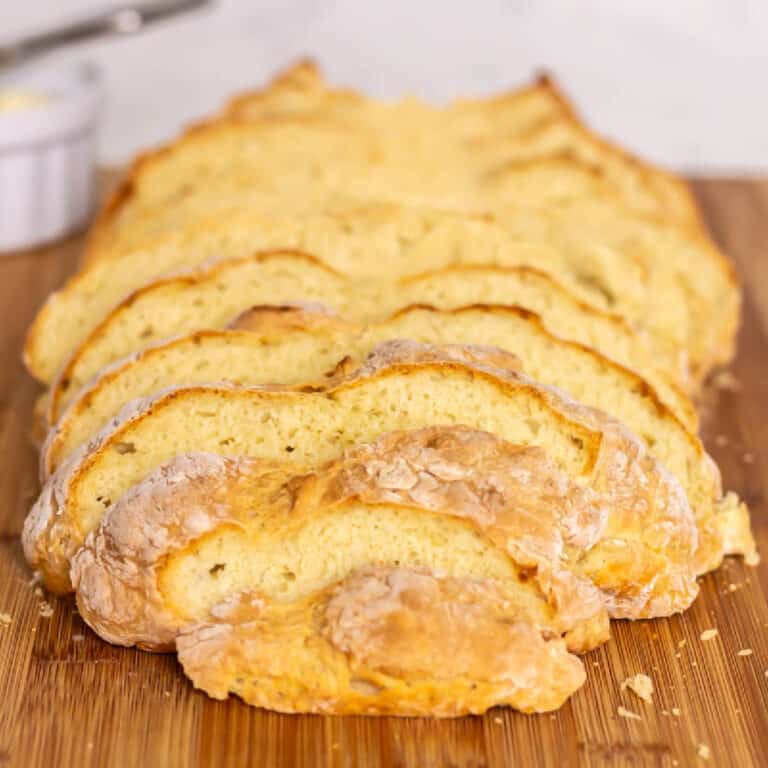 Irish soda bread cut into slices on a cutting board