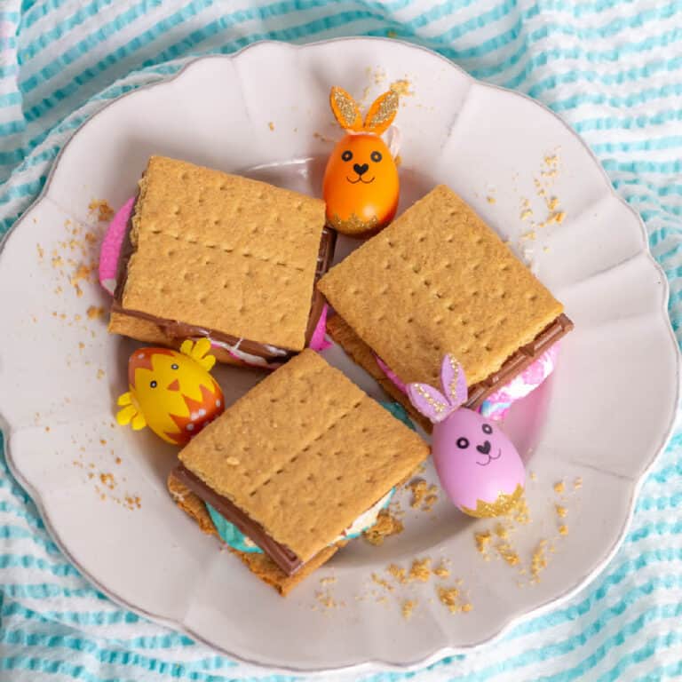Three Peeps S'mores on a white plate with bunny decorations