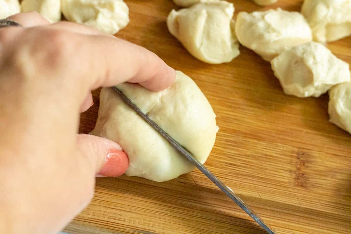 Cutting pieces of dough with a sharp knife
