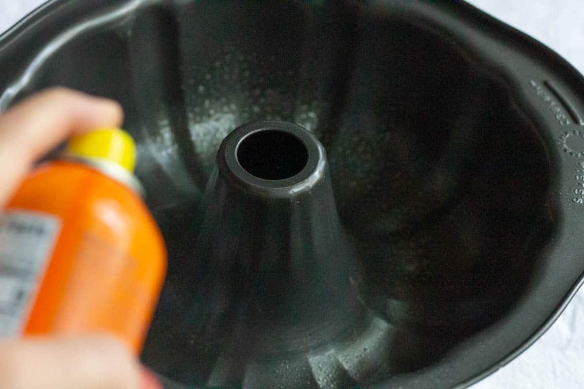 Spraying a dark colored Bundt pan with non-stick cooking spray