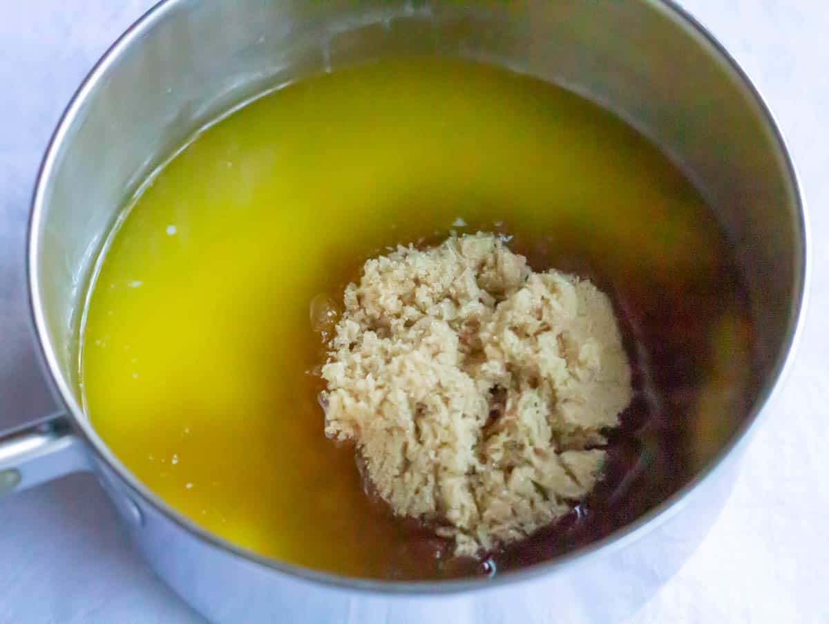 Brown sugar added to melted butter in a medium saucepan