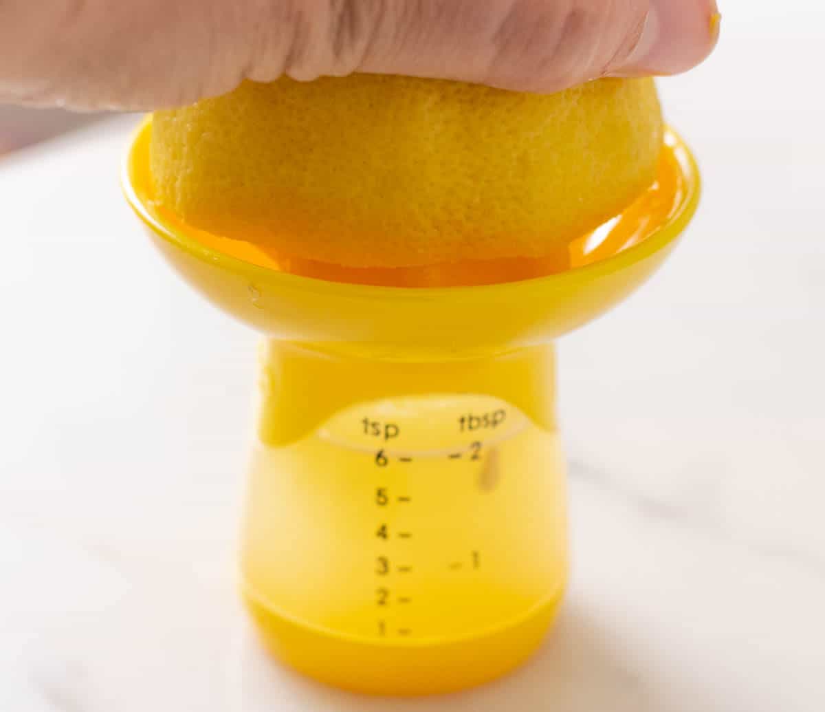 Juicing a lemon on a small juicer
