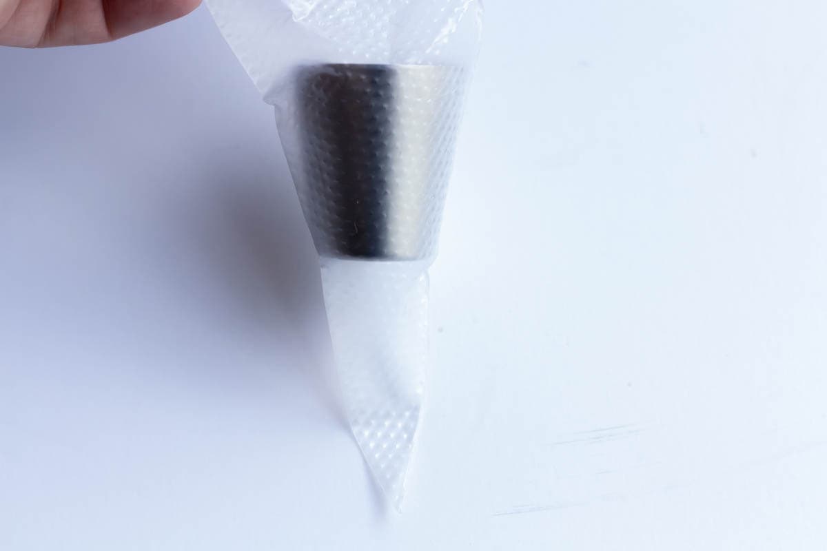 A Russian piping tip inside of an uncut 16-inch piping bag