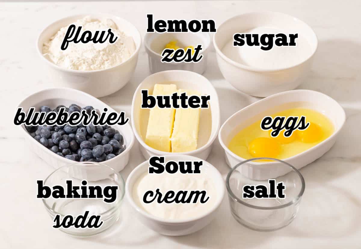 Ingredients for lemon blueberry pound cake in individual bowls and labeled