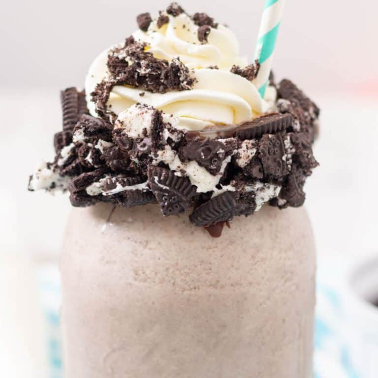 Cookies and cream shake in a mason jar with an aqua straw