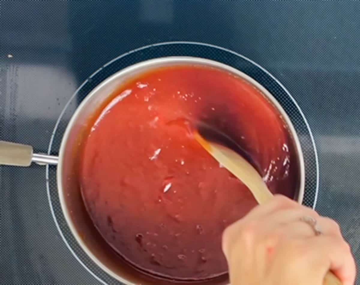 Stirring ingredients for bbq sauce in a medium saucepan
