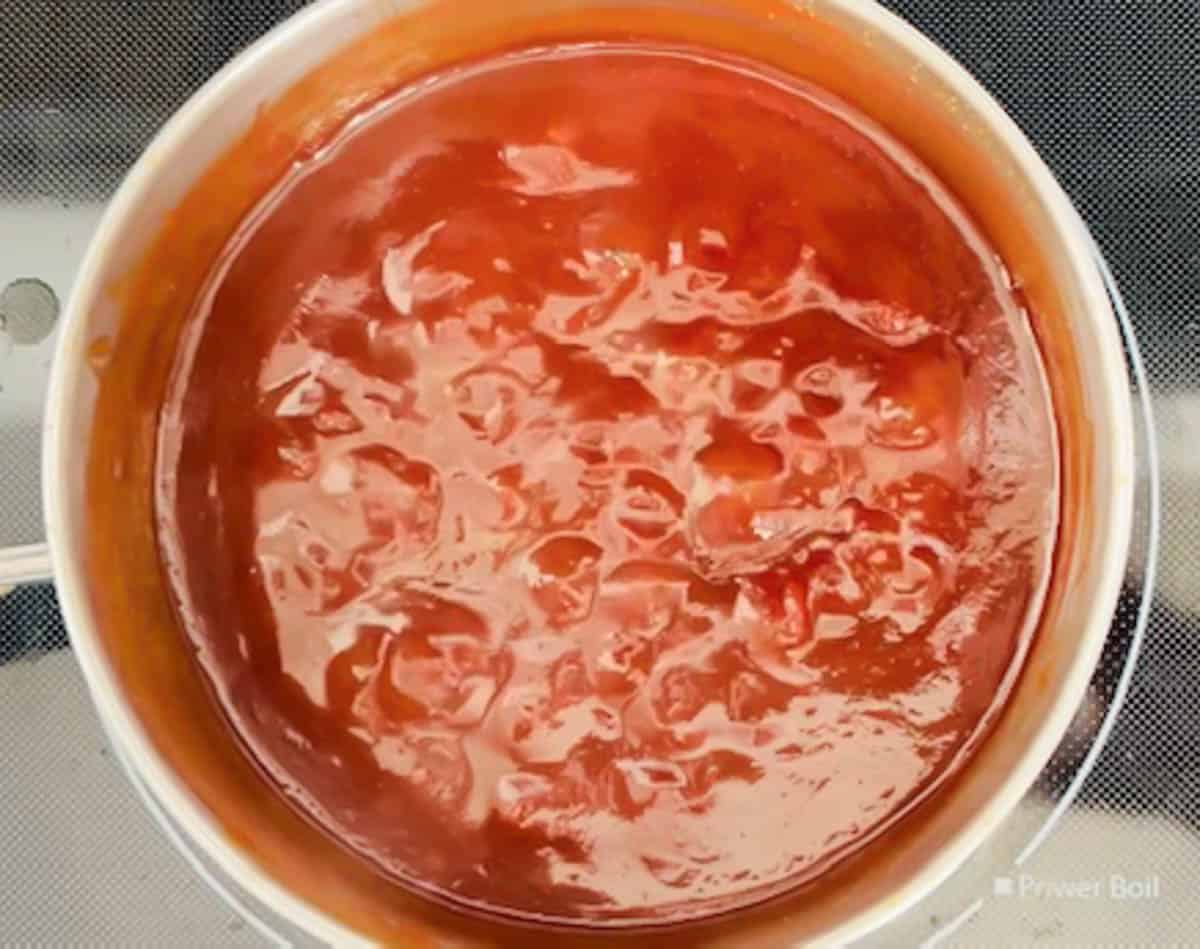 BBQ sauce simmering in a medium saucepan