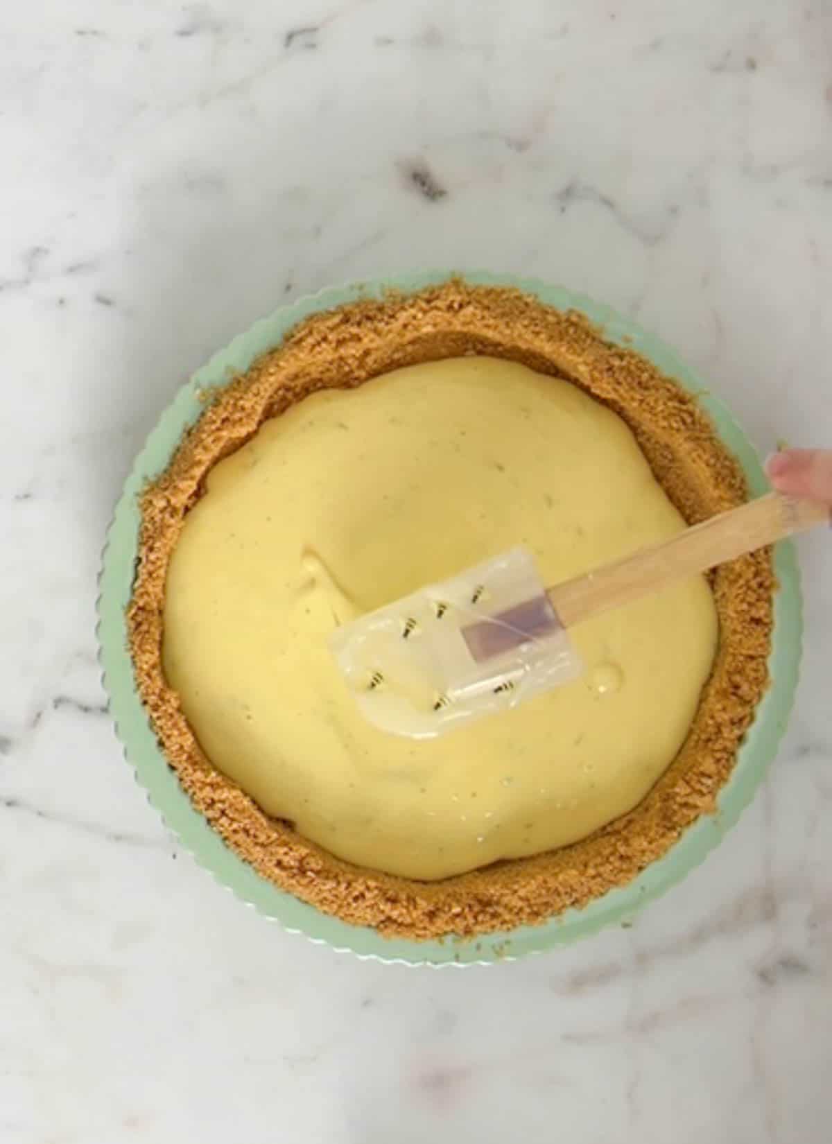Smoothing pie filling with a rubber/silicone spatula