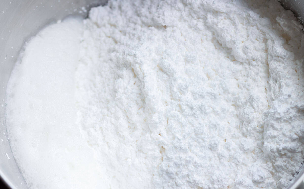 Royal Icing Recipe with Meringue Powder | thewendthousekitchen.com Powdered sugar added to the water, meringue powder, cream of tartar mixture in the bowl of a stand mixer.