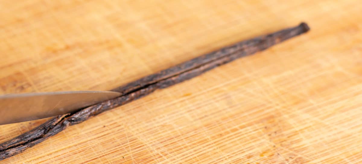 Easy Bourbon Vanilla Extract | thewendthousekitchen.com Cutting a vanilla bean open length wise with a small sharp knife.