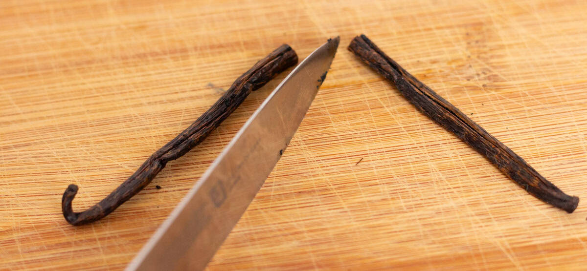 Easy Bourbon Vanilla Extract | thewendthousekitchen.com A vanilla bean cut in half with a small sharp knife.