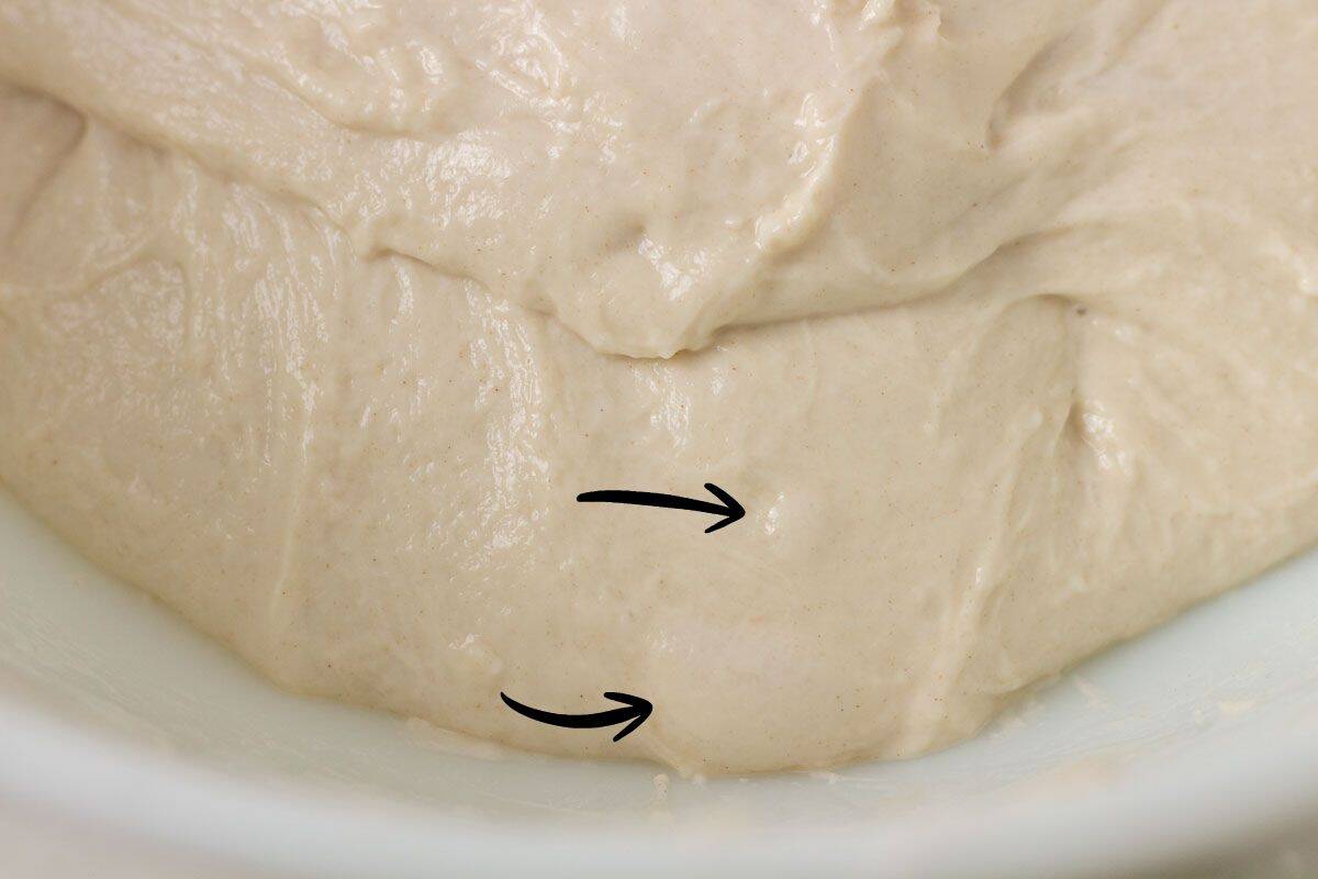 How To Make Artisan Sourdough Bread | thewendthousekitchen.com Sourdough dough after bulk fermentation with visible bubbles.