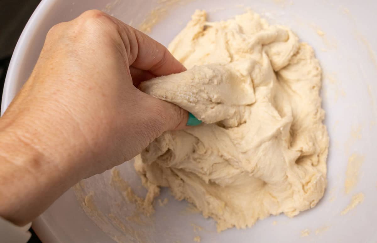How To Make Artisan Sourdough Bread | thewendthousekitchen.com Pinching dough between fingers to incorporate salt.
