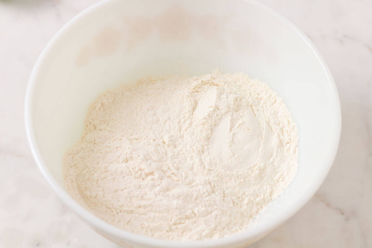 How To Make Artisan Sourdough Bread | thewendthousekitchen.com All-purpose flour and bread flour combined in a large bowl.