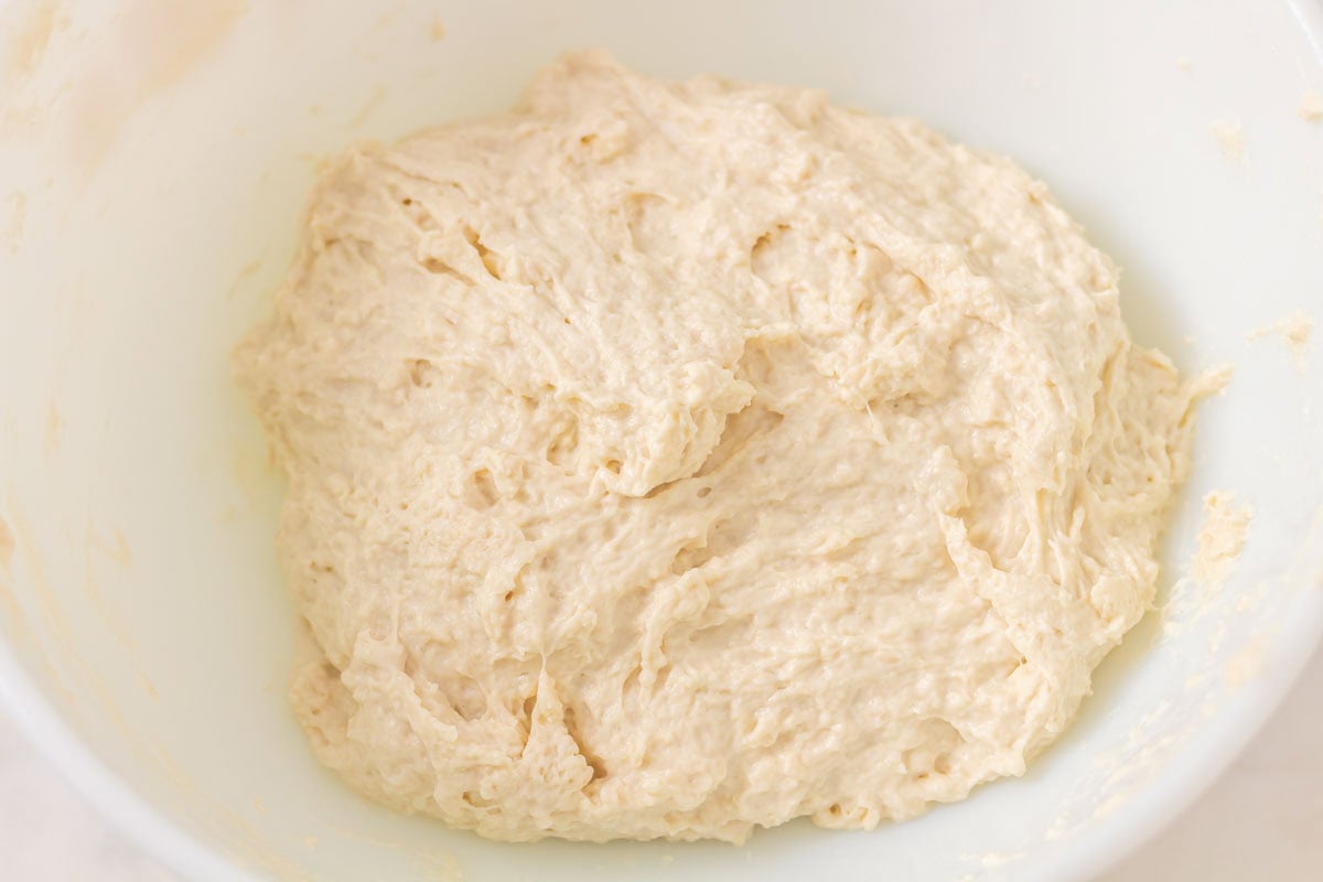 How To Make Artisan Sourdough Bread | thewendthousekitchen.com Sourdough bread dough mixed together in a large bowl.