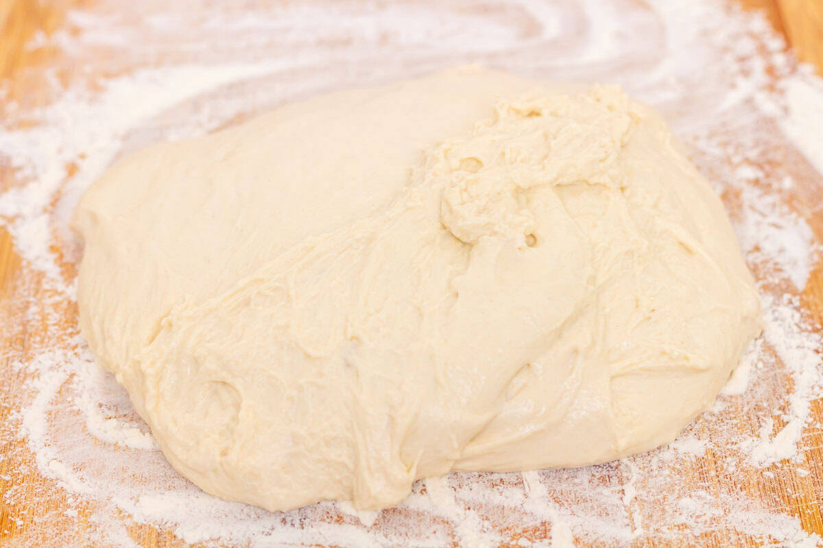 How To Make Artisan Sourdough Bread | thewendthousekitchen.com Sourdough dough turned out onto a floured cutting board.