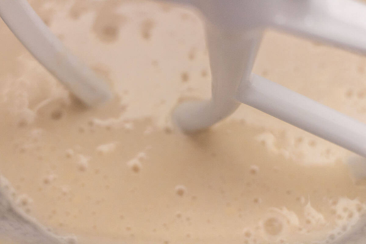 Sour Dough Discard Cinnamon Rolls | thewendthousekitchen.com Water, yeast, sugar and sourdough discard blended together in the bowl of a stand mixer with a paddle attachment.