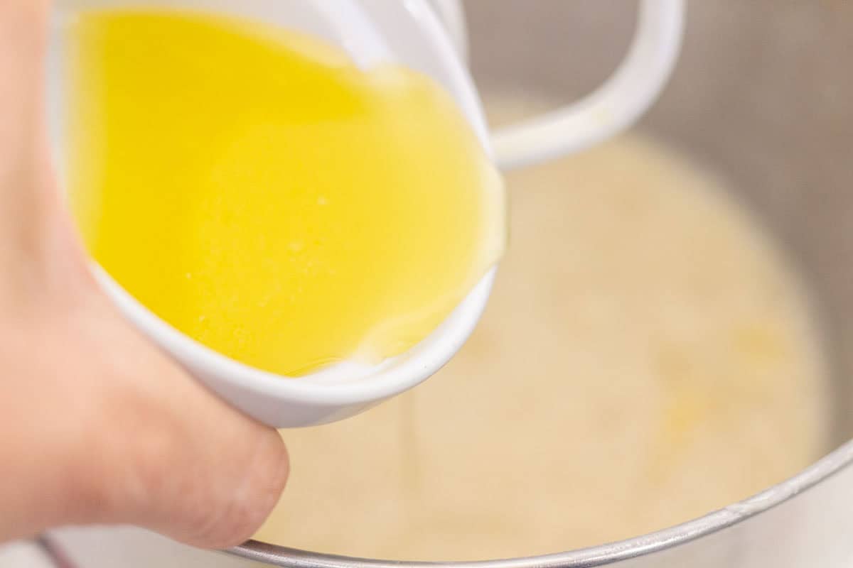 Sour Dough Discard Cinnamon Rolls | thewendthousekitchen.com Adding melted butter to the bowl of a stand mixer.