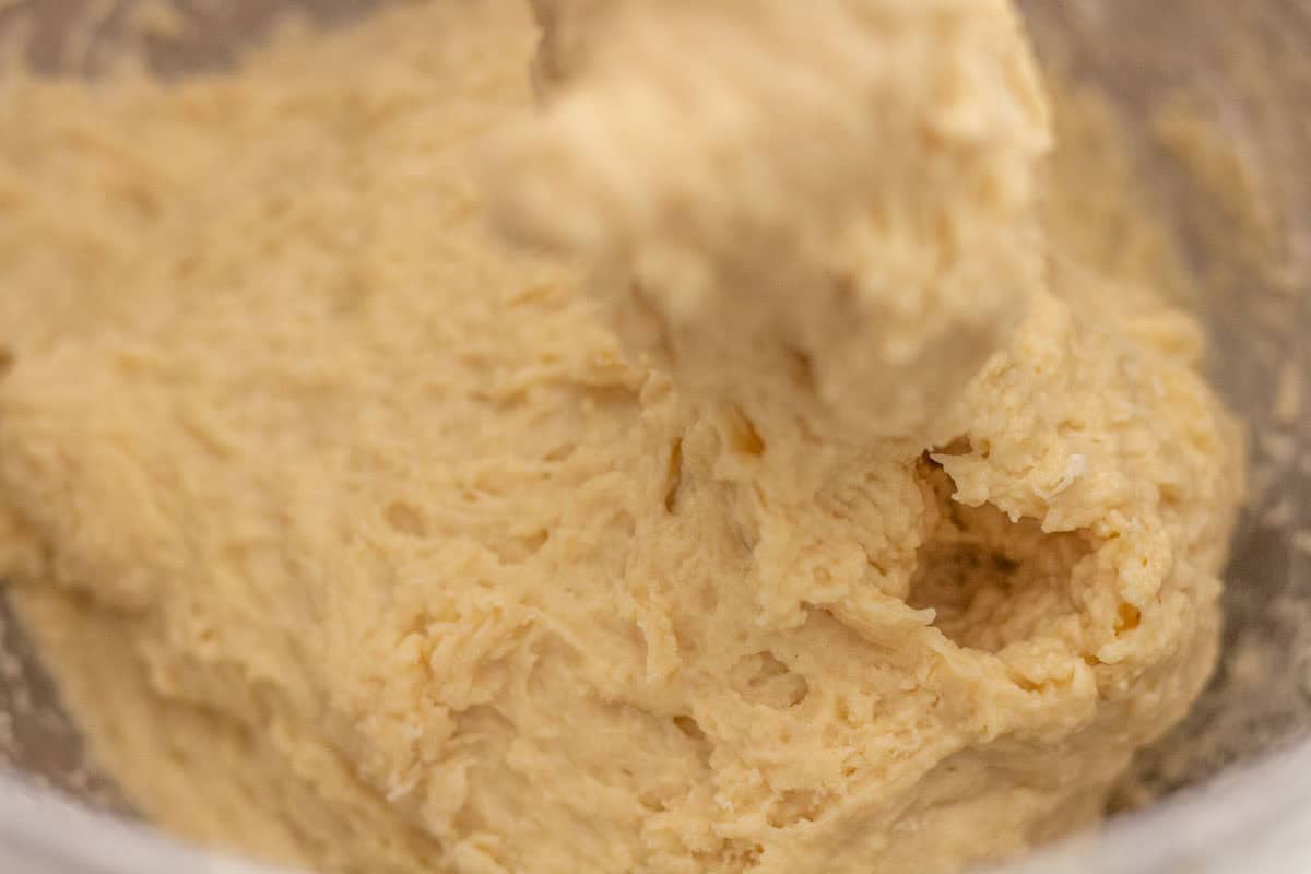 Sour Dough Discard Cinnamon Rolls | thewendthousekitchen.com Cinnamon roll dough mixed together in the bowl of a stand mixer.