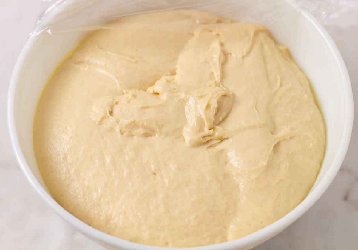 Sour Dough Discard Cinnamon Rolls | thewendthousekitchen.com Cinnamon dough that has risen in a large white Pyrex bowl.