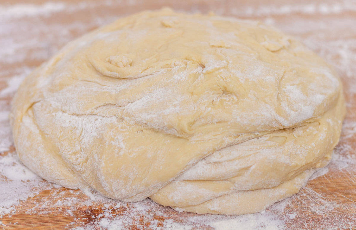 Sour Dough Discard Cinnamon Rolls | thewendthousekitchen.com Lightly floured dough on a floured cutting board.