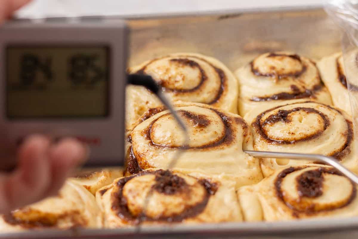 Sour Dough Discard Cinnamon Rolls | thewendthousekitchen.com A thermometer inside of raw cinnamon rolls.