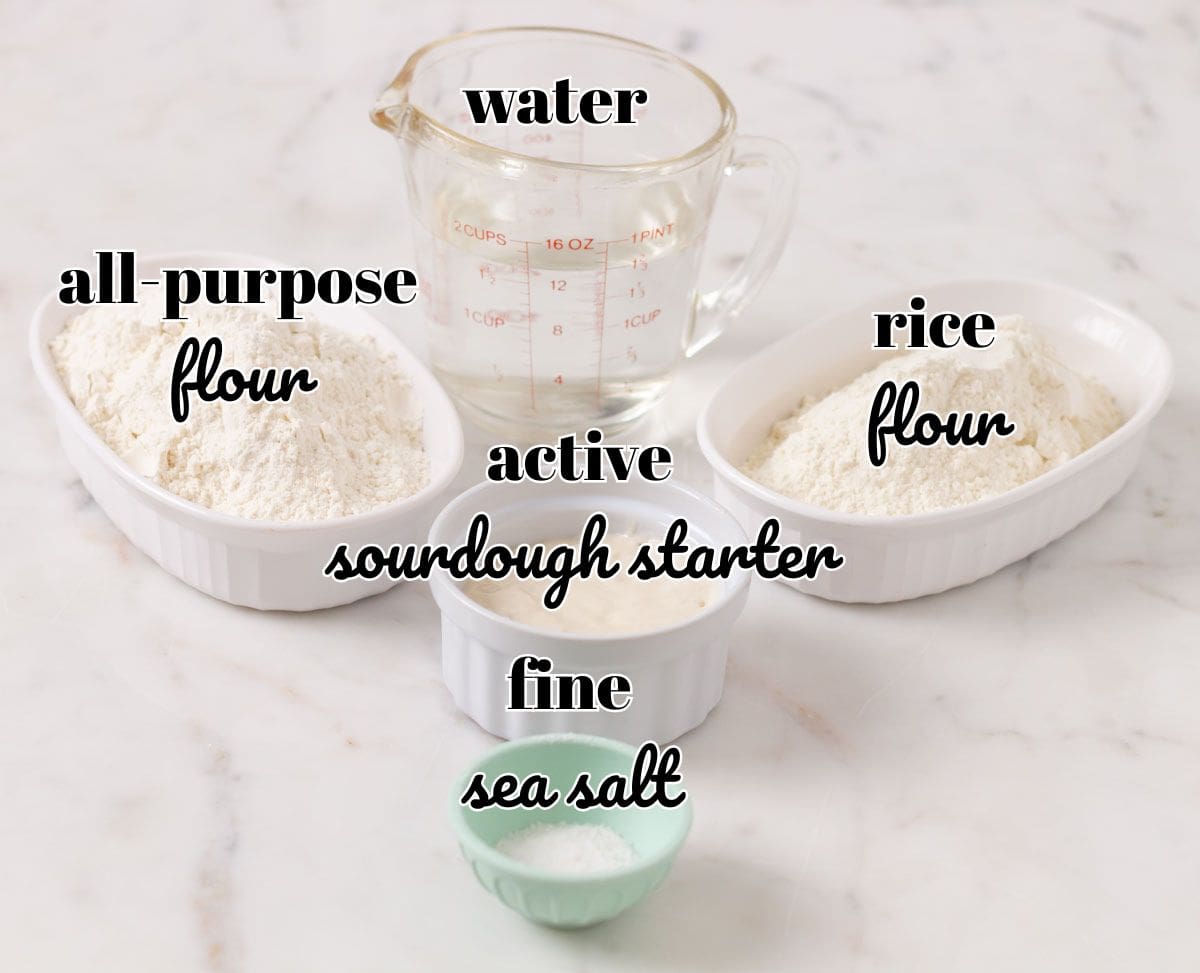 How To Make Artisan Sourdough Bread | thewendthousekitchen.com Ingredients for sourdough bread in individual bowls and labeled.