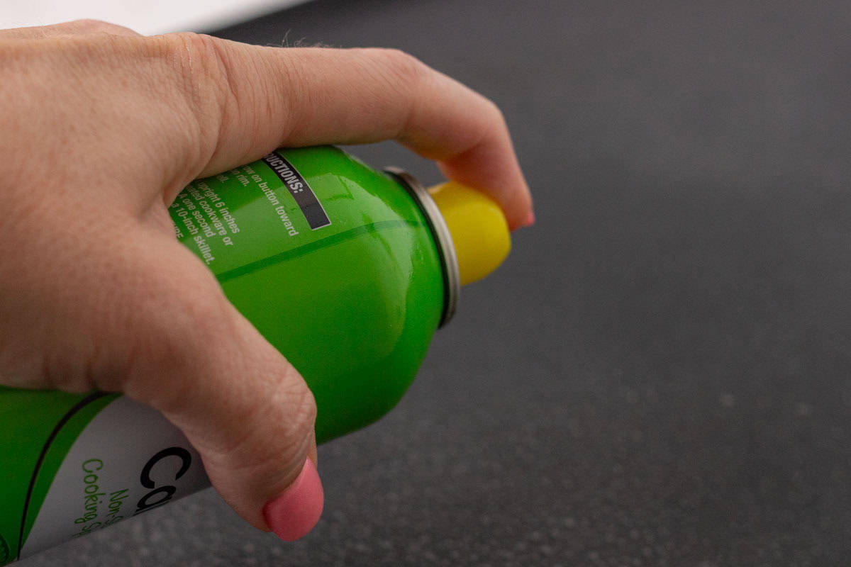 Sourdough Discard English Muffin Recipe | thewendthousekitchen.com Spraying an electric skillet with nonstick cooking spray.