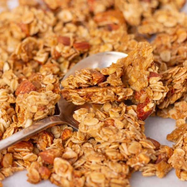 Granola spread out with a spoon.