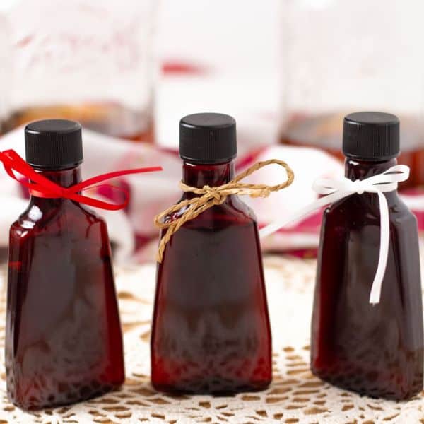 Bourbon vanilla extract in three bottles with ribbons tied around them.