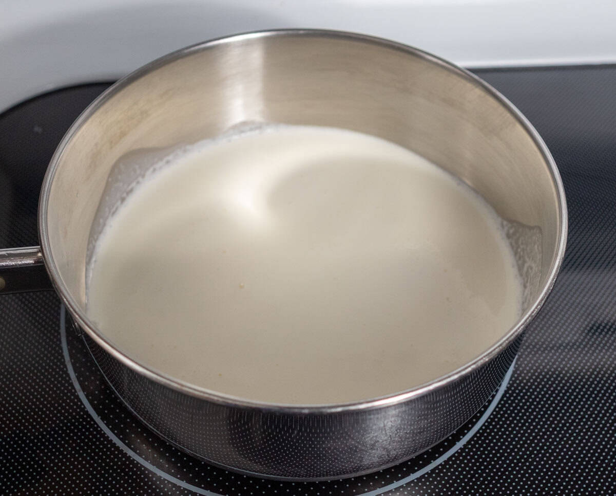 Chocolate Mint Cake with Mint Cream Cheese Frosting | thewendthousekitchen.com Heavy whipping cream in a small saucepan on the stove.