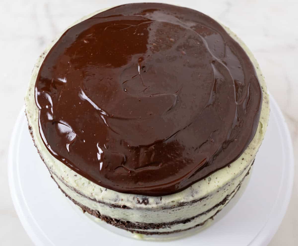 Chocolate Mint Cake with Mint Cream Cheese Frosting | thewendthousekitchen.com Top view of chocolate mint cake with the ganache spread over the top.