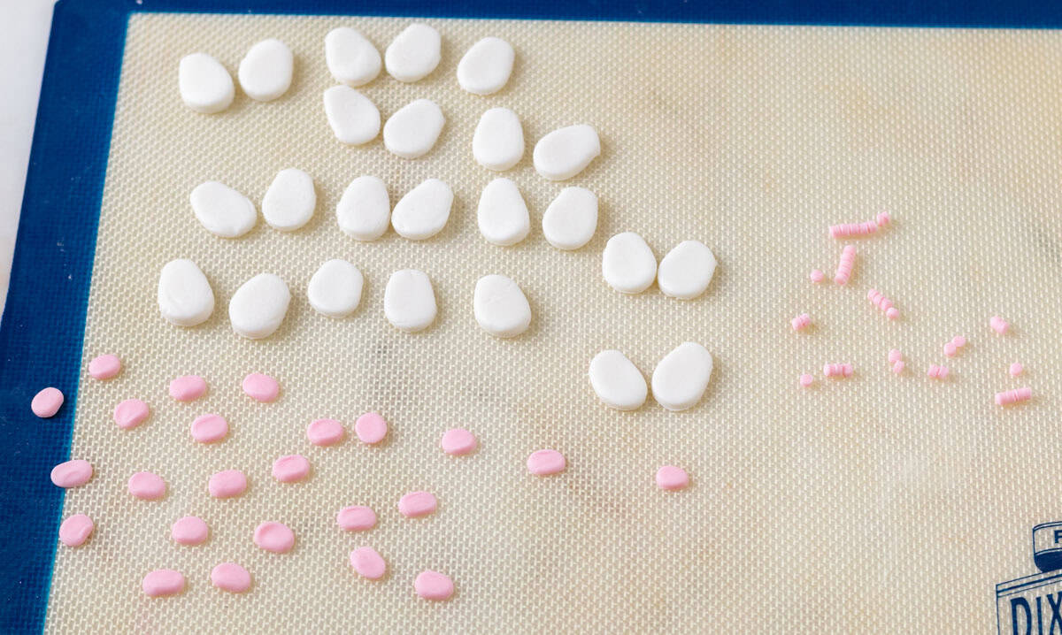 Bunny Cupcakes for Easter (Bunny Butt Cupcakes) | thewendthousekitchen.com 24 white fondant bunny feet and medium and small size pink paw pads for bunny feet on a Silpat mat.