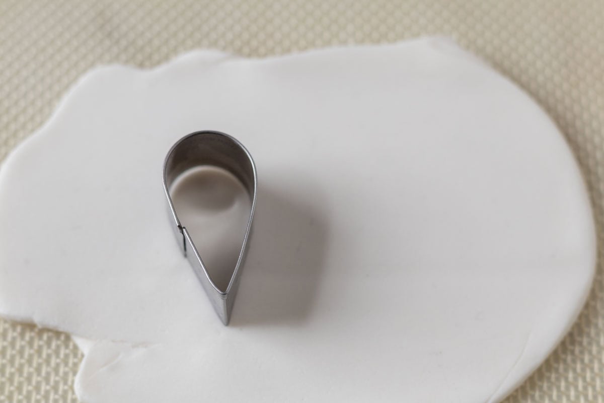 Bunny Cupcakes for Easter (Bunny Butt Cupcakes) | thewendthousekitchen.com A small teardrop cutter on top of rolled out white fondant.