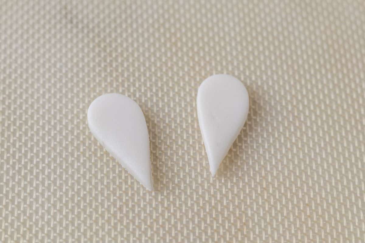 Bunny Cupcakes for Easter (Bunny Butt Cupcakes) | thewendthousekitchen.com Two teardrop shapes of white fondant on a Silpat.