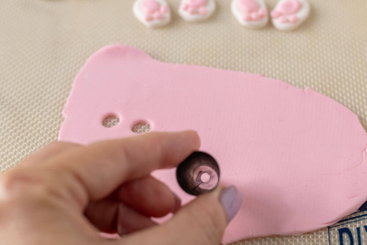 Bunny Cupcakes for Easter (Bunny Butt Cupcakes) | thewendthousekitchen.com Using a piping tip 12 to cut out circles on a pink piece of rolled out fondant.