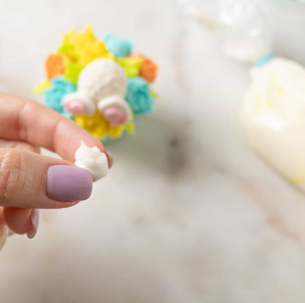 Bunny Cupcakes for Easter (Bunny Butt Cupcakes) | thewendthousekitchen.com A dot of white buttercream on the back of a mini marshmallow.